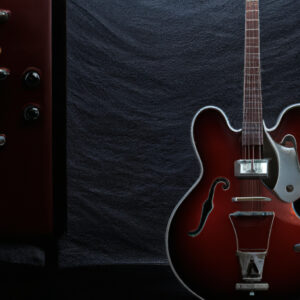 an image showcasing the Fender CD-60SCE, capturing the rich mahogany finish, elegant cutaway design, and the gleaming chrome hardware, all under the spotlight of a dimly lit stage