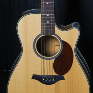 An image showcasing the enchanting Taylor 214ce-K guitar in all its glory: capture the intricate craftsmanship of its solid Sitka spruce top, layered koa back and sides, and the stunning natural wood finish