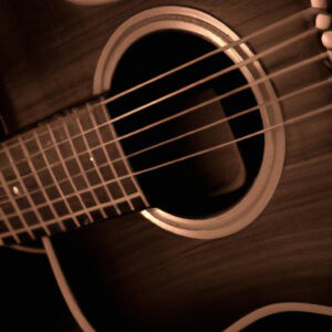 An image capturing the exquisite Yamaha FG800 Folk Acoustic Guitar Vintage Tint, showcasing its rich mahogany body, smooth vintage tint finish, and intricate soundhole rosette, evoking a timeless and soulful musical experience