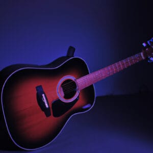 E the soulful essence of Yamaha FS800 T Concert as a seasoned musician passionately strums the sleek acoustic guitar, its rich mahogany finish glimmering under the stage lights, inviting melodies to fill the air