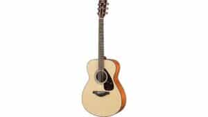 Light-colored acoustic guitar, featuring a cutaway design, wooden fretboard, and tuning pegs, ideal for music enthusiasts and professional musicians.