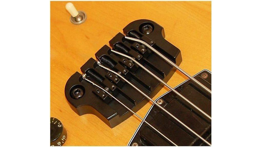 High-quality bass guitar bridge assembly showcasing precision hardware and strings for professional sound and stability.
