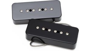 High-quality black and gray humbucker guitar pickups with metal poles, perfect for electric guitars and music enthusiasts.
